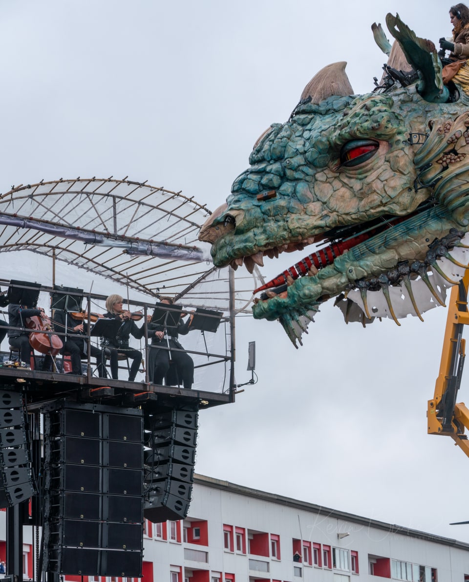 Head of Le Dragon de Calais beside the musicians' platform, Calais, France
