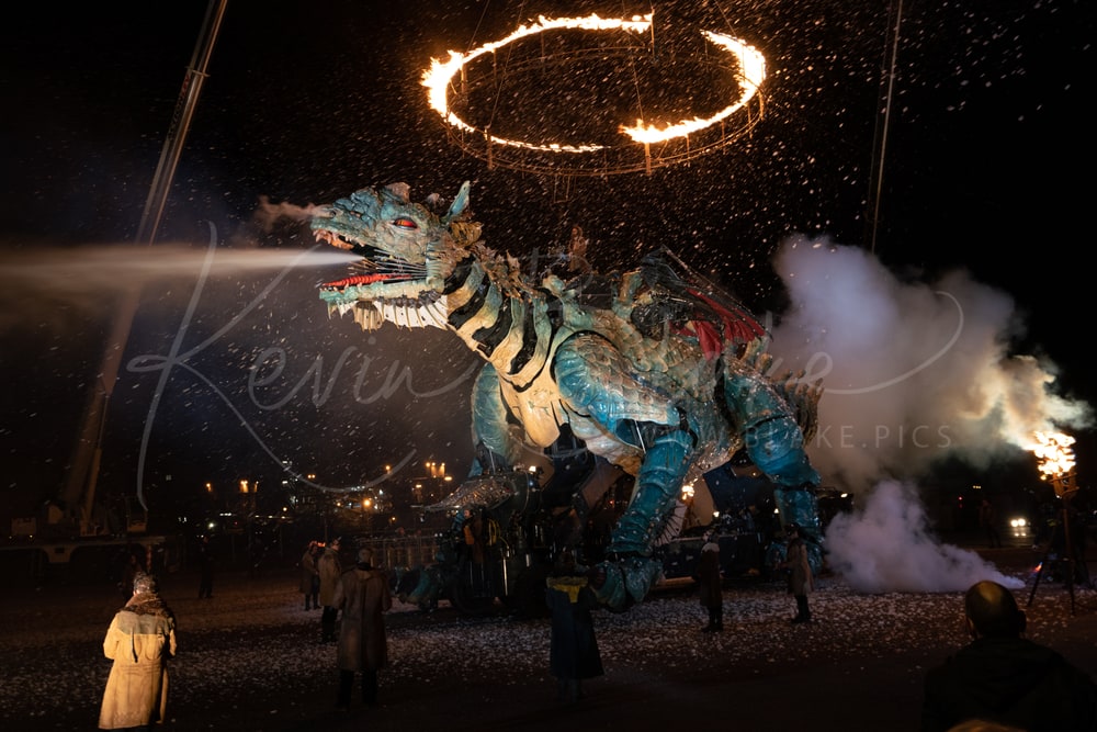 Le Dragon de Calais blowing steam beneath a ring of fire at night, Calais, France
