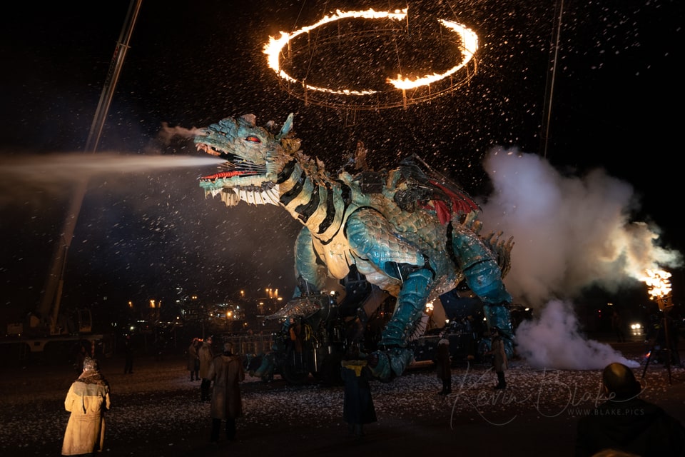 Le Dragon de Calais blowing steam beneath a ring of fire at night, Calais, France