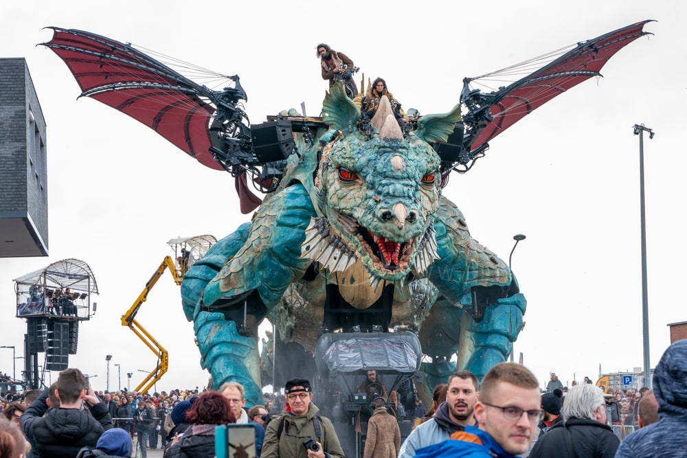 Le Dragon de Calais with its wings spread above the crowd, Calais, France