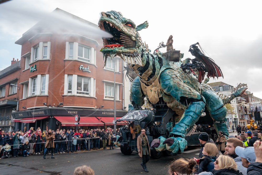 Le Dragon de Calais spraying water over the crowd on a street corner, Calais, France