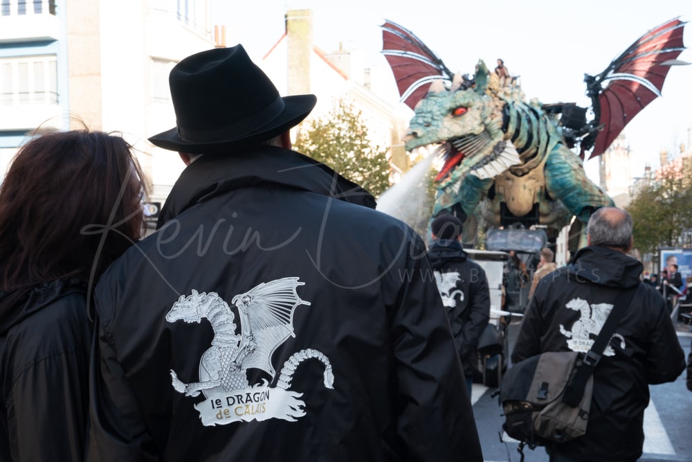 Crew in Le Dragon de Calais jackets watching the dragon parade, Calais, France