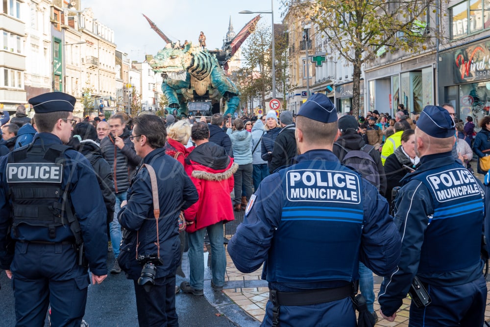 Police keeping back the crowd as Le Dragon de Calais parades, Calais, France